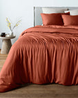 bambaw cozy terracotta duvet cover and pillows on a bed with a neutral background