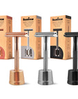 Three Bambaw safety razors with stands in different colors with their packaging on a white background