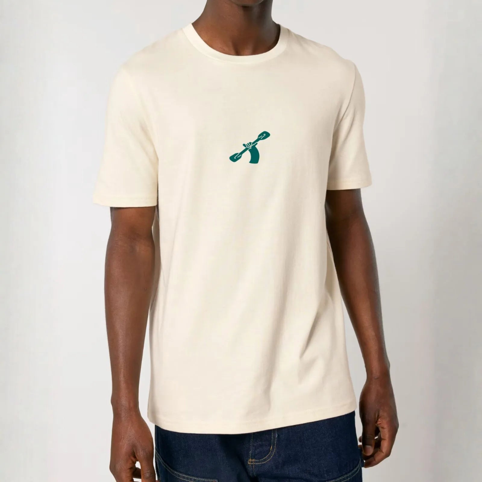 Natural raw white cotton t-shirt with a green City to Ocean logo worn by a man on a white background